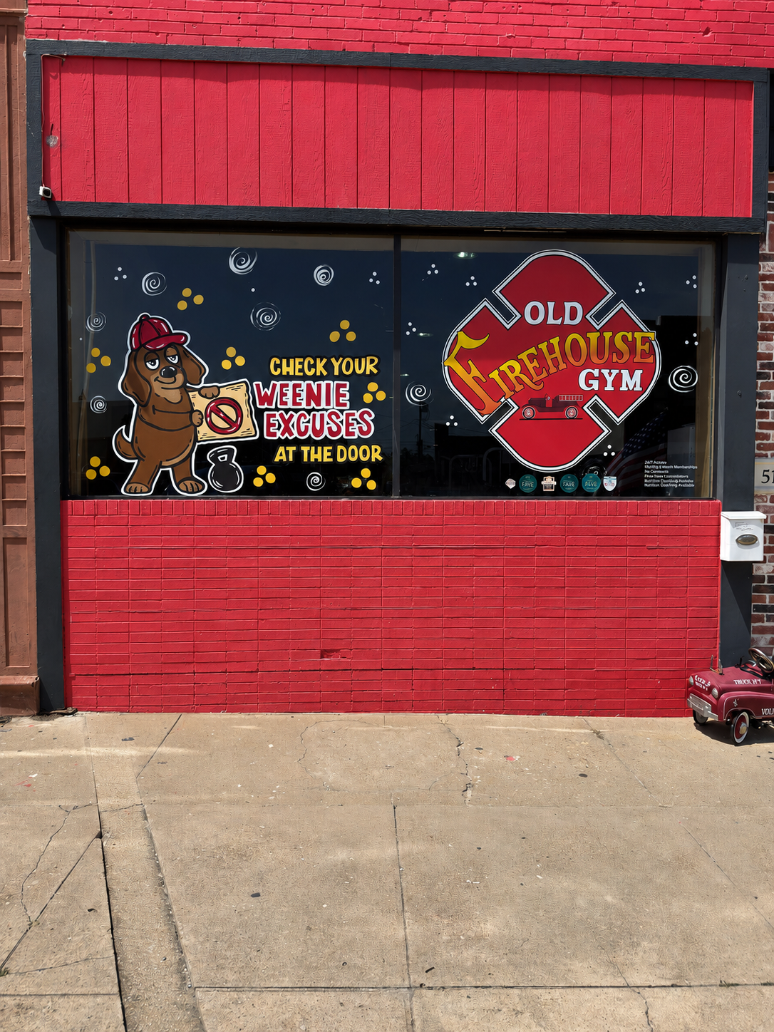 Old Firehouse Gym front window with hand-painted signage