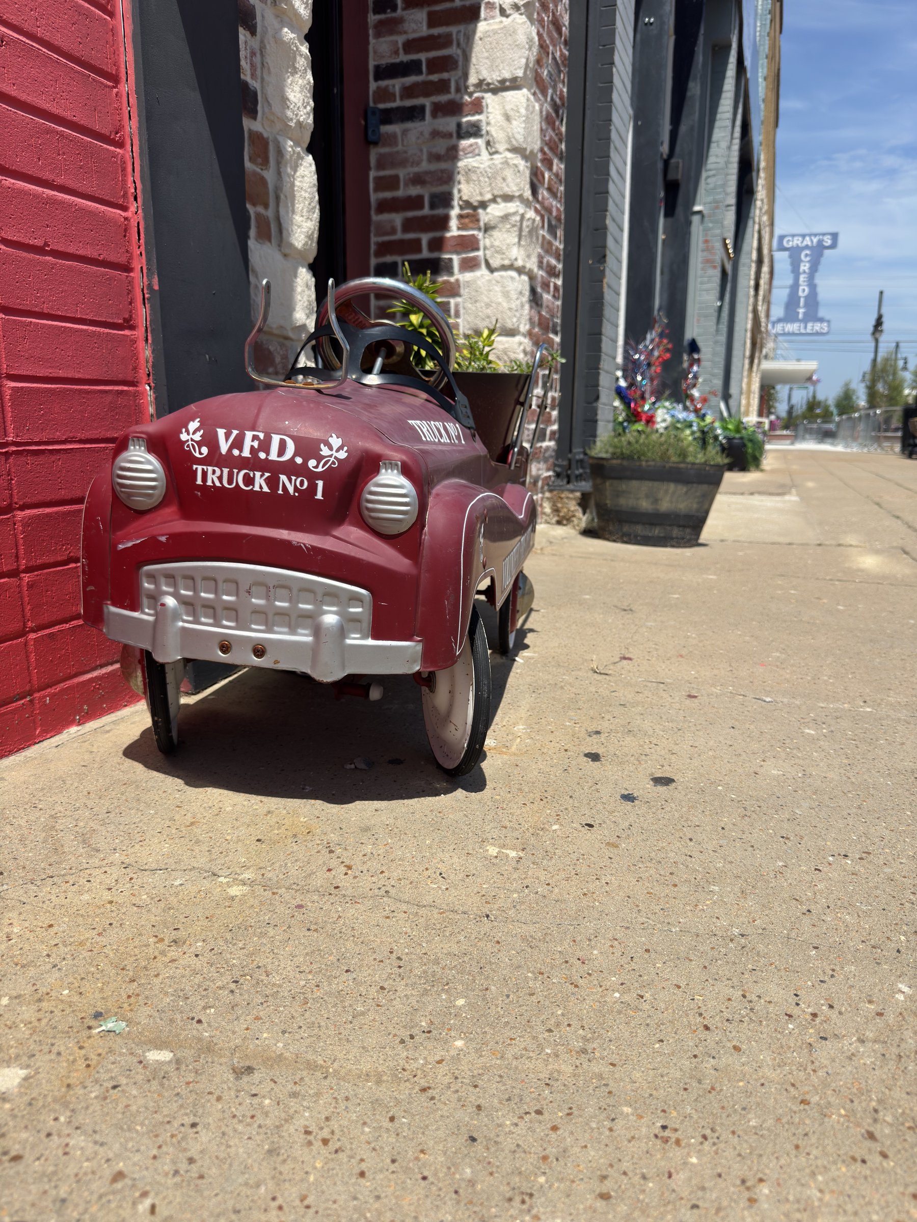 Vintage V.F.D. pedal firetruck outside Old Firehouse Gym